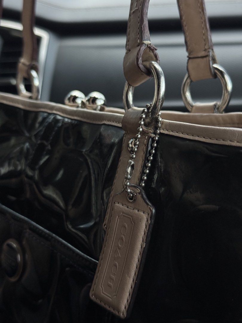 Coach Patent Leather Embossed Tote Bag (Category: Luxury Bags & Wallets) located in Cabanatuan. Submitted by dgbordador (Listing ID 1462576227, Image 3). Description: - Genuine black patent leather Coach tote bag - Elegant embossed pattern - Contrasting beige trim and handles - Convenient back zipper pocket - Interior features multiple compartments and a secure clasp closure - Serial number C138-523487 visible - Ideal for everyday use.