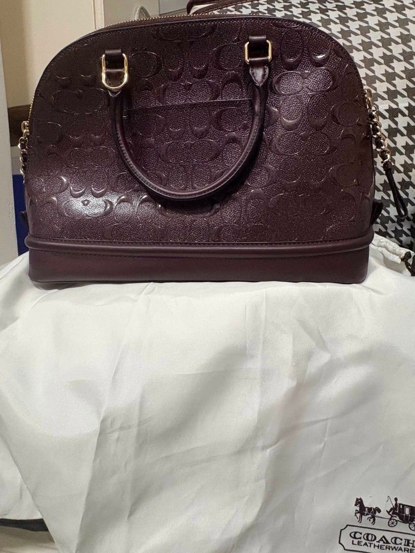 Coach Sierra Satchel (Category: Luxury Bags & Wallets) located in Quezon City. Submitted by mmmm2000 (Listing ID 1462615870, Image 1). Description: This is a Coach Sierra Satchel in signature debossed patent leather, featured in a deep oxblood tone with gold-tone hardware. [1].