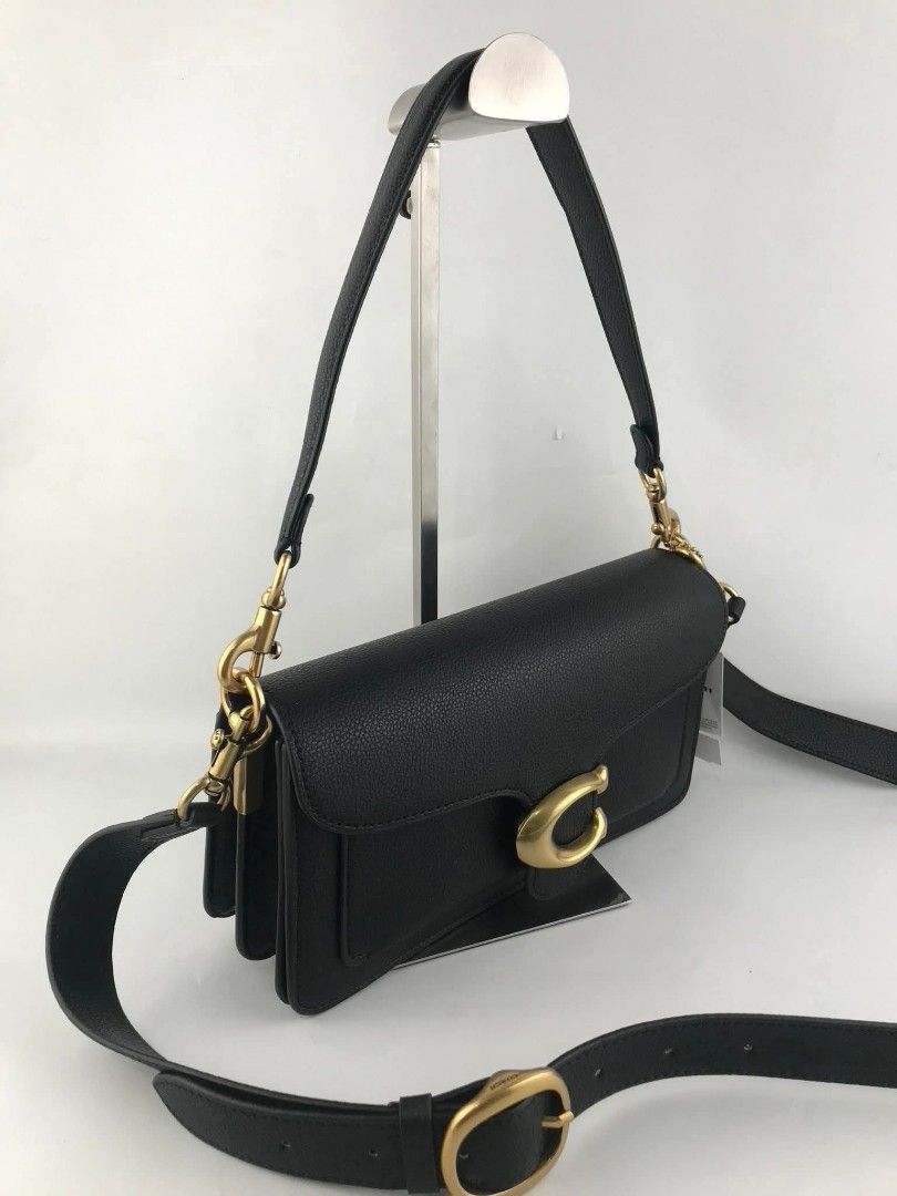 Coach Tabby Shoulder Bag 26 Black Pebble Leather (Category: Shoulder Bags) located in Manila. Submitted by catpanganiban_ (Listing ID 1462635152, Image 3). Description: - Coach Tabby bag - Color: Black - Material: Pebble leather - Hardware: Gold - Features: Signature C clasp, detachable shoulder strap, longer crossbody strap - Interior: Multiple compartments - Condition: Clean inside and out - Versatile: Great for everyday use or evenings out.