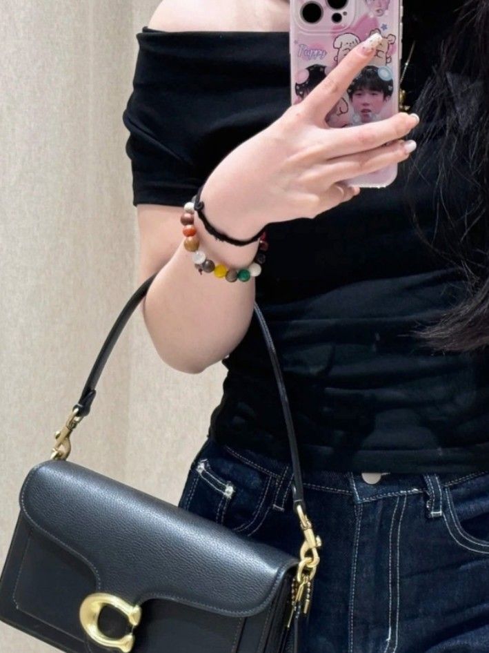 Coach Tabby Shoulder Bag 26 Black Pebble Leather (Category: Shoulder Bags) located in Manila. Submitted by catpanganiban_ (Listing ID 1462635152, Image 2). Description: - Coach Tabby bag - Color: Black - Material: Pebble leather - Hardware: Gold - Features: Signature C clasp, detachable shoulder strap, longer crossbody strap - Interior: Multiple compartments - Condition: Clean inside and out - Versatile: Great for everyday use or evenings out.