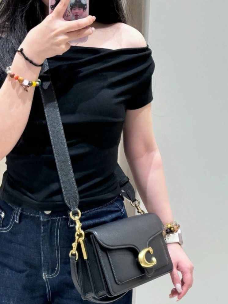 Coach Tabby Shoulder Bag 26 Black Pebble Leather (Category: Shoulder Bags) located in Manila. Submitted by catpanganiban_ (Listing ID 1462635152, Image 1). Description: - Coach Tabby bag - Color: Black - Material: Pebble leather - Hardware: Gold - Features: Signature C clasp, detachable shoulder strap, longer crossbody strap - Interior: Multiple compartments - Condition: Clean inside and out - Versatile: Great for everyday use or evenings out.