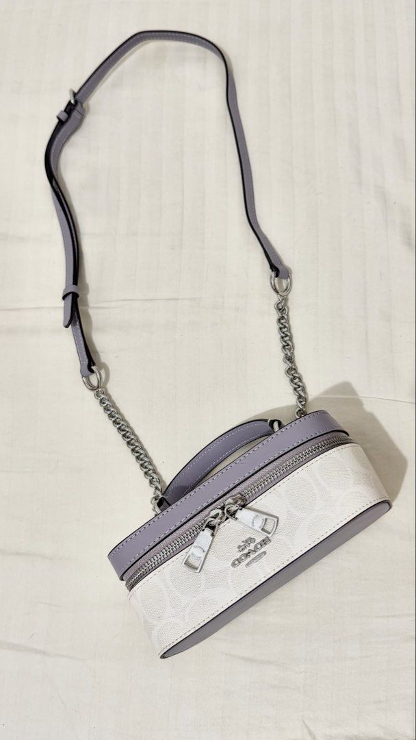 Coach Train Case Crossbody (Category: Luxury Bags & Wallets) located in Manila. Submitted by alianneug41369 (Listing ID 1462575254, Image 2). Description: - Coach vanity case bag - Signature print in white and lavender - Silver hardware with zip closure - Top handle - Detachable crossbody strap - Small and compact size - Ideal for carrying essentials 📍Dasmarinas City, Cavite.