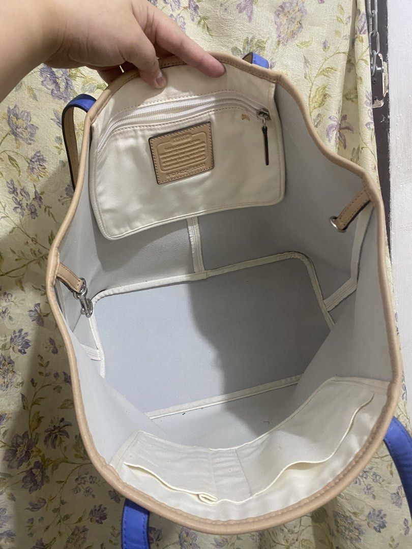 Coach White Leather Tote Bag (Category: Luxury Bags & Wallets) located in Binan City. Submitted by prelovedlagunaph (Listing ID 1462620715, Image 3). Description: - Authentic Coach white leather tote bag - Stylish tan trim and blue strap accents - Large interior with multiple pockets for organization - Comes with original Coach leather tag - Ideal for everyday use and errands.