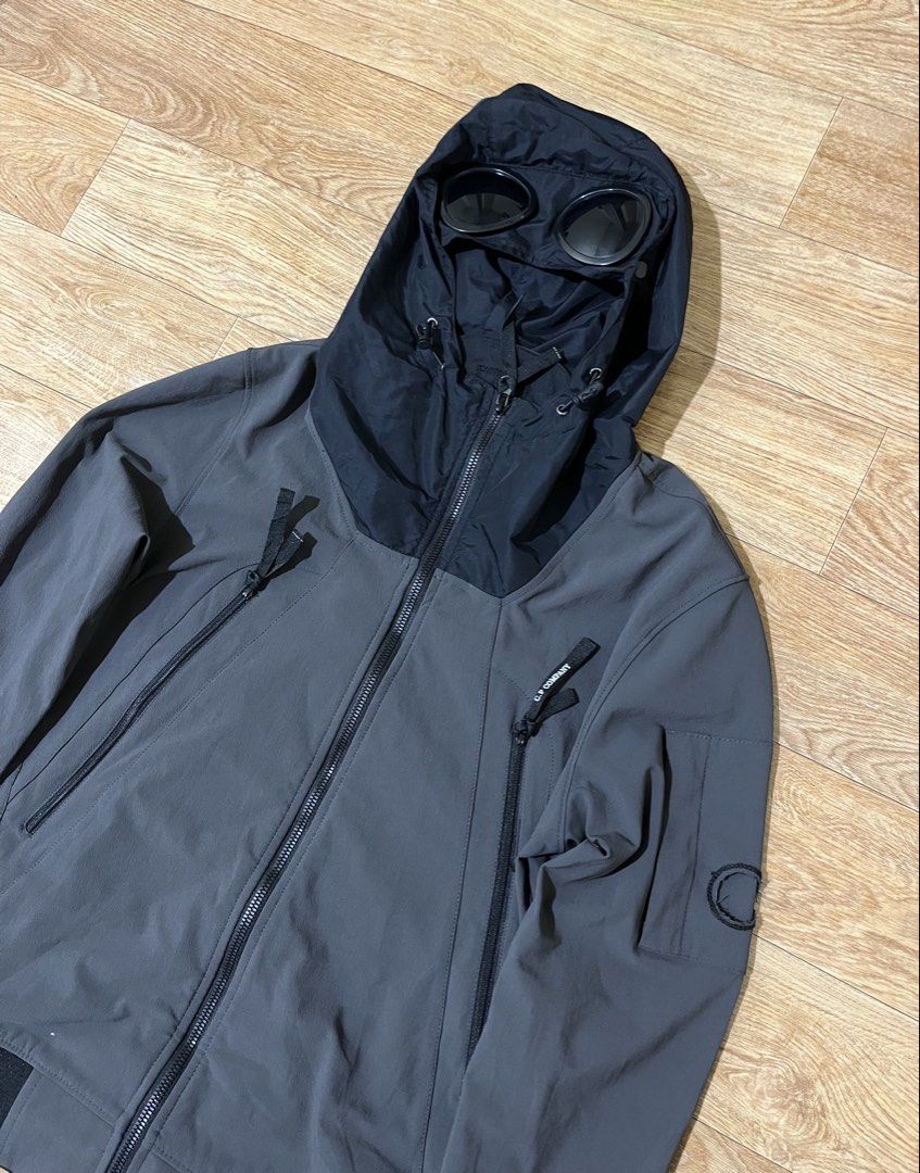 C.P. Company soft shell jacket (Category: Coats, Jackets and Outerwear) located in Zamboanga. Submitted by alterramz08 (Listing ID 1462634621, Image 3). Description: charcoal grey C.P. Company soft shell jacket, featuring their signature integrated goggles on the hood. Size medium Width 19 Length 24 Excellent Condition Issue nasa last pic Price : 1,500Pesos .