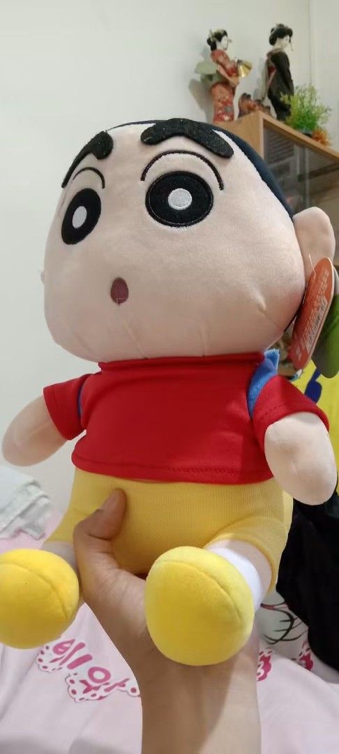 Crayon Shin-chan Plush Toy with Backpack (Category: Plushies & Soft Toys) located in Gapan. Submitted by montesnora80204 (Listing ID 1462678311, Image 1). Description: - Adorable Crayon Shin-chan plush toy. - Dressed in his classic red shirt and yellow shorts. - Comes with a cute blue backpack. - Brand new with tag still attached. - Ideal gift for any Shin-chan enthusiast!.