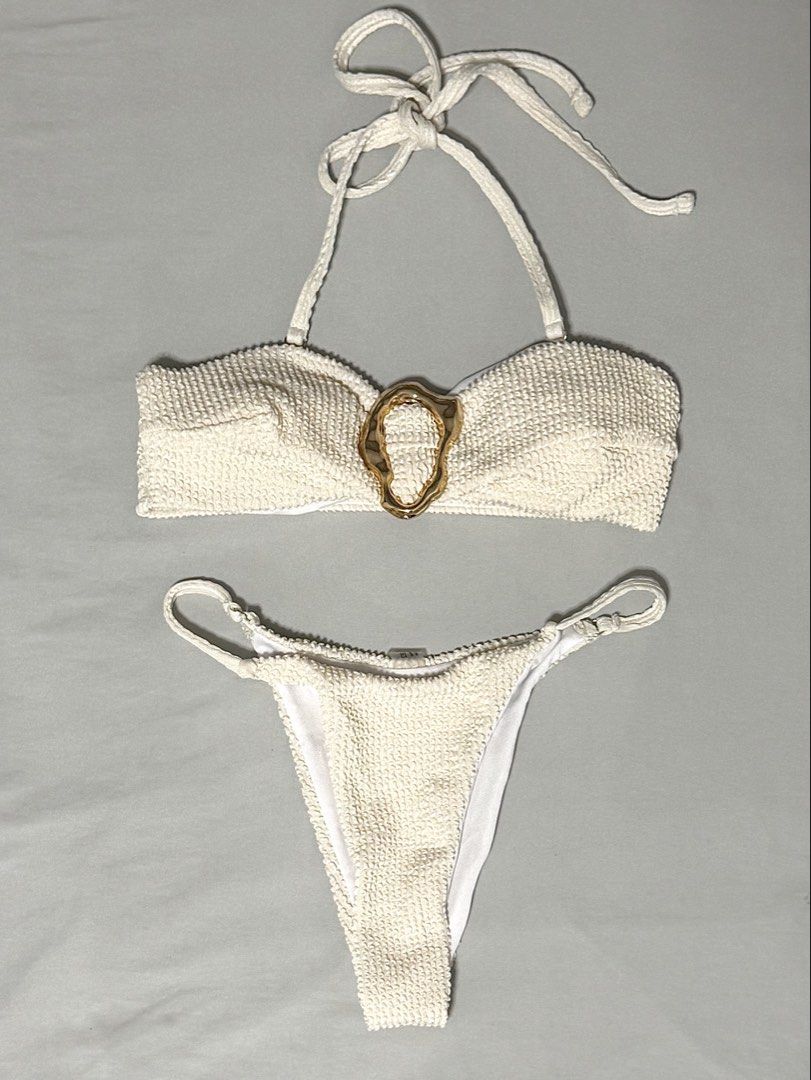 cream bikini set (Category: Bikinis & Swimsuits) located in Caloocan City. Submitted by chiblonded (Listing ID 1462548885, Image 2). Description: - Cream textured bikini set - Bandeau top with gold ring detail - Matching high-waisted bottoms - Comes with a drawstring cover-up skirt - Ideal for beach or pool days - Comfortable and stylish.
