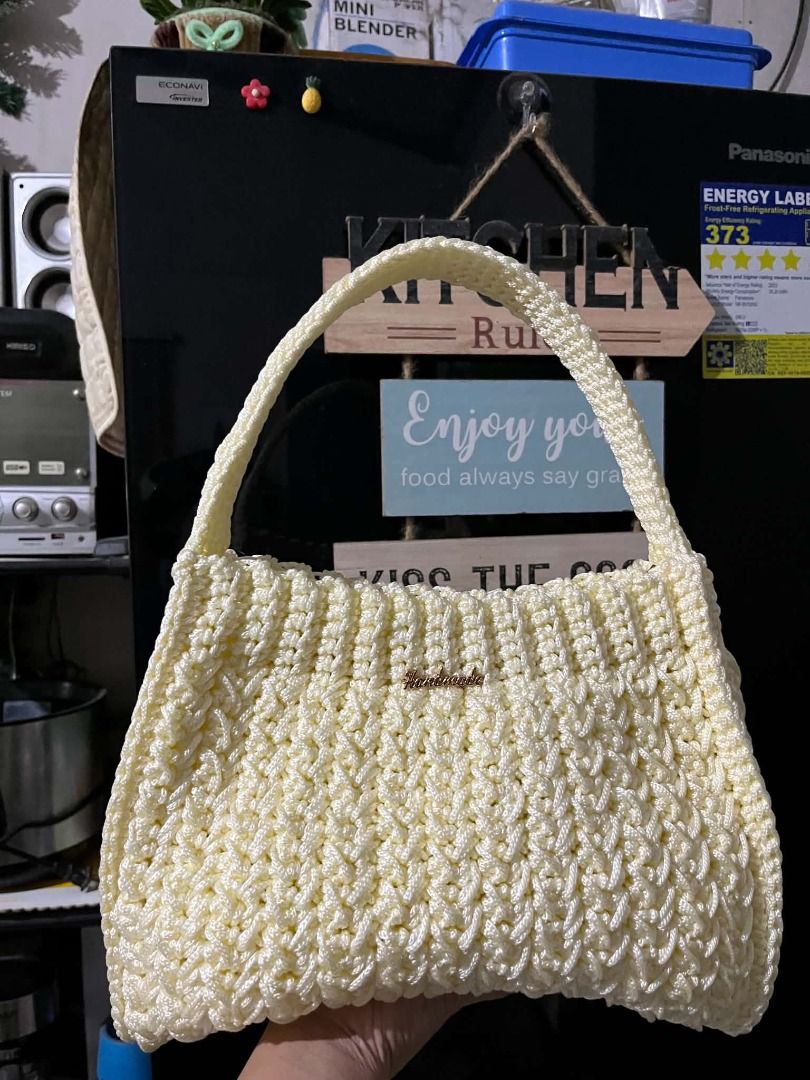 Cream Crochet Shoulder Bag with Handle (Category: Shoulder Bags) located in Caloocan City. Submitted by jnksknotsandfuzzyflowers (Listing ID 1462458983, Image 2). Description: - Handmade crochet shoulder bag in a beautiful cream color. - Features a unique textured stitch pattern all over. - Sturdy, crocheted handle for comfortable carrying. - Adorned with a small metallic 'handmade' tag. - Ideal for casual outings and adding a unique touch to you