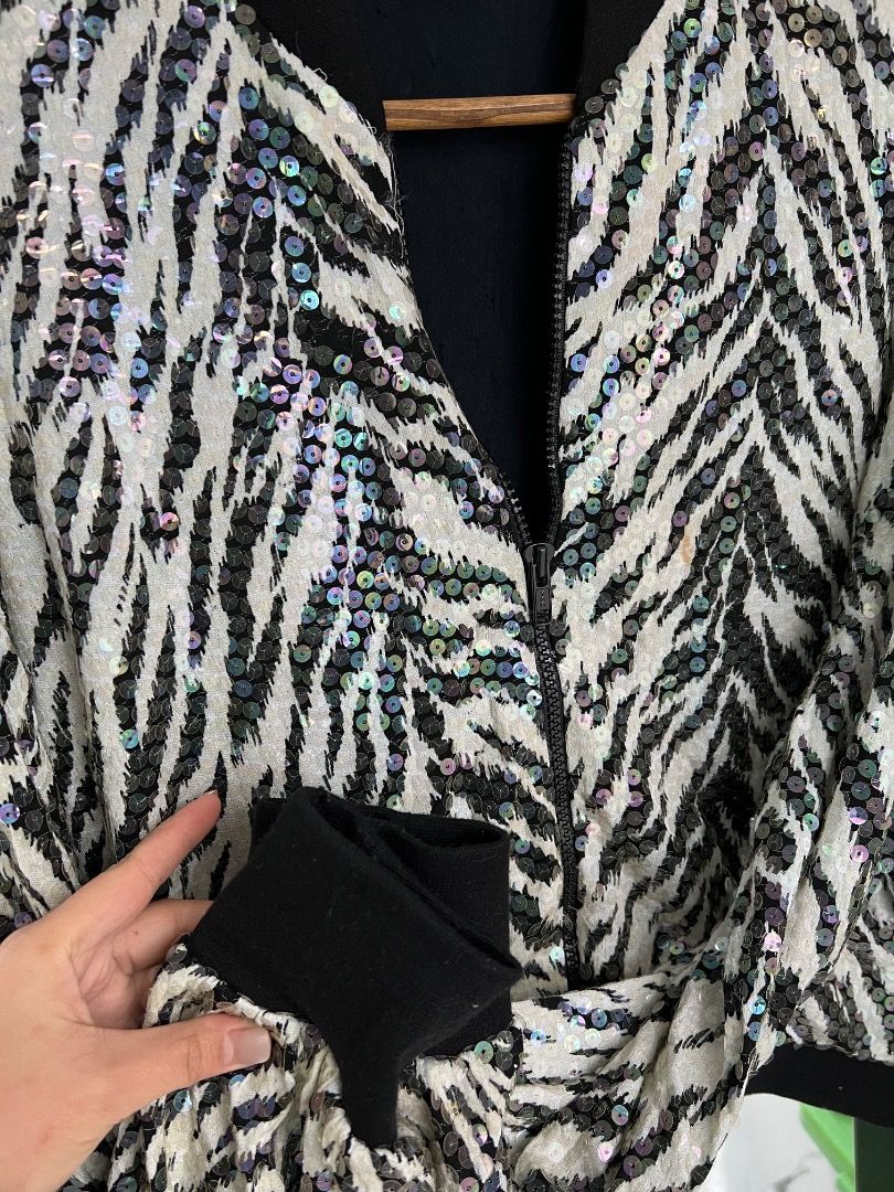 CRISCIONE Sequin Zebra Print Bomber Jacket (Category: Coats, Jackets and Outerwear) located in Baguio. Submitted by pureearth.5f1c08 (Listing ID 1462550232, Image 3). Description: - Unique zebra print bomber jacket - All-over sequin embellishments - Black ribbed cuffs and hem - Front zipper closure - Fully lined in black - Perfect statement piece for any outfit - Fun and eye-catching design.