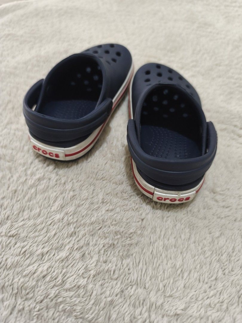 Crocs Junior Crocband Clog in Navy Red (Category: Babies & Kids Fashion) located in Pasig City. Submitted by mmdaswani (Listing ID 1462453162, Image 2). Description: Crocs Junior Crocband Clog in Navy Red in size C6 (13.2 cm or 5.1 in) Original Price: PHP 2,800 RFS: loved but outgrown.