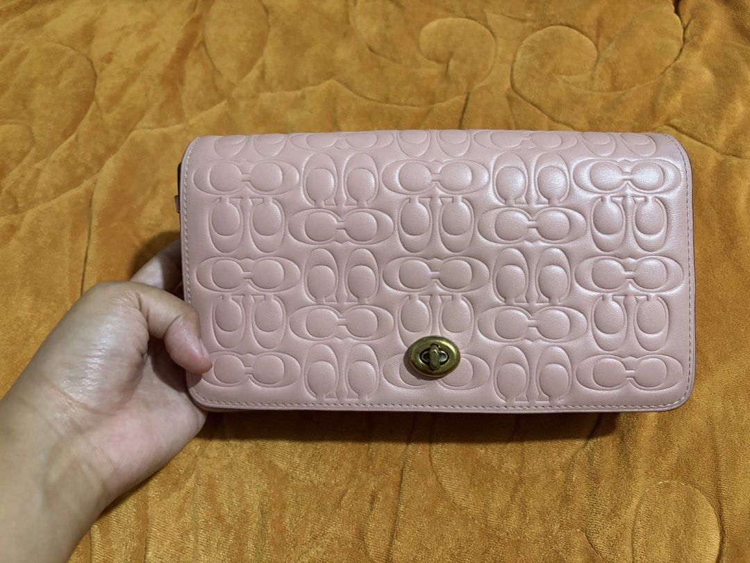 Crossbody Bag (Category: Luxury Bags & Wallets) located in General Santos City (Dadiangas). Submitted by saaradiane08346 (Listing ID 1462507139, Image 1). Description: - Pink Coach crossbody bag - All-over signature embossing - Pretty floral interior lining - Includes a small attached coin purse - Gold hardware and turnlock closure - Adjustable strap for comfort - Perfect for daily use or evening events.