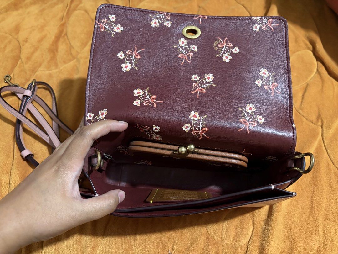 Crossbody Bag (Category: Luxury Bags & Wallets) located in General Santos City (Dadiangas). Submitted by saaradiane08346 (Listing ID 1462507139, Image 2). Description: - Pink Coach crossbody bag - All-over signature embossing - Pretty floral interior lining - Includes a small attached coin purse - Gold hardware and turnlock closure - Adjustable strap for comfort - Perfect for daily use or evening events.