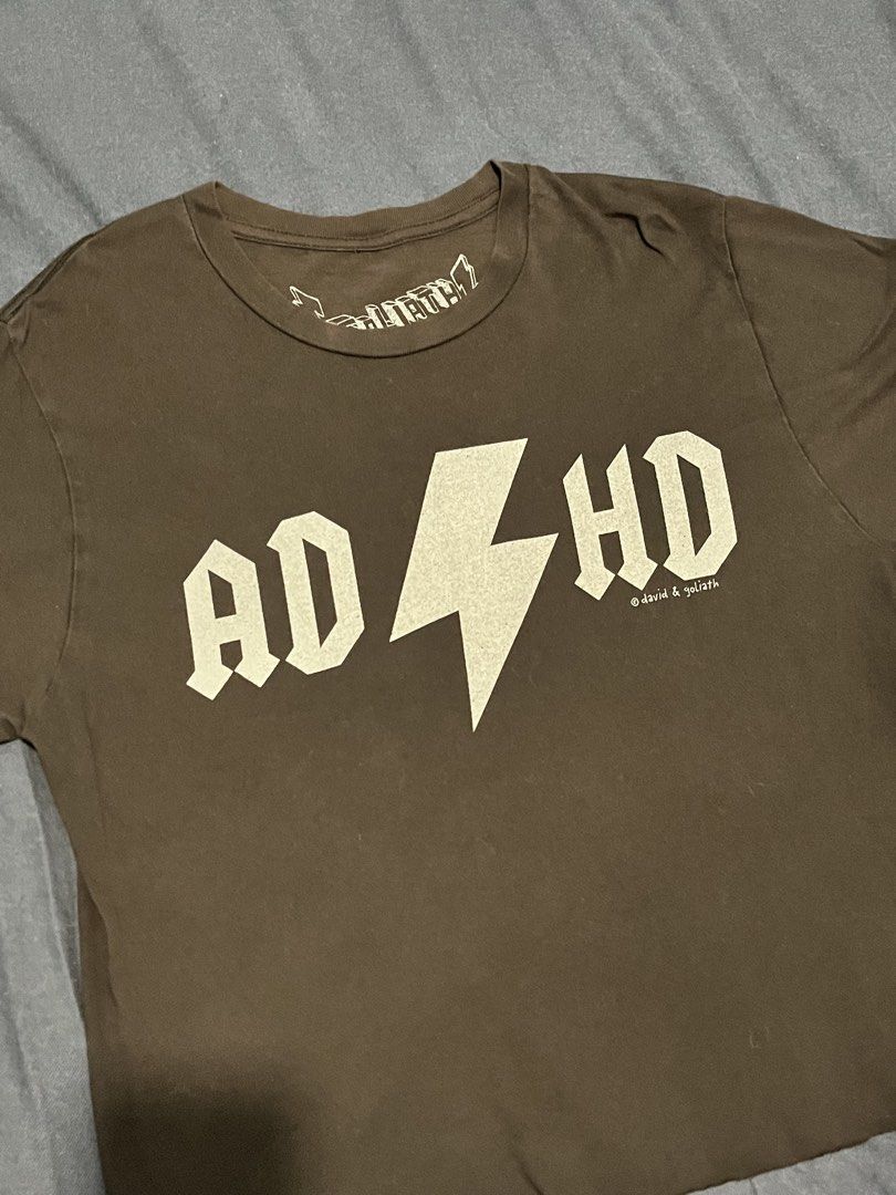 ADHD Cropped Graphic T-Shirt (Category: Tshirts & Polo Shirts ) located in Quezon City. Submitted by vwfndrskprs (Listing ID 1462517826, Image 3). Description: - Brand: David & Goliath - Design: Bold 'ADHD' graphic with lightning bolt - Material: 100% soft cotton - Size: Small 17.5” width / 35” chest 21” length.