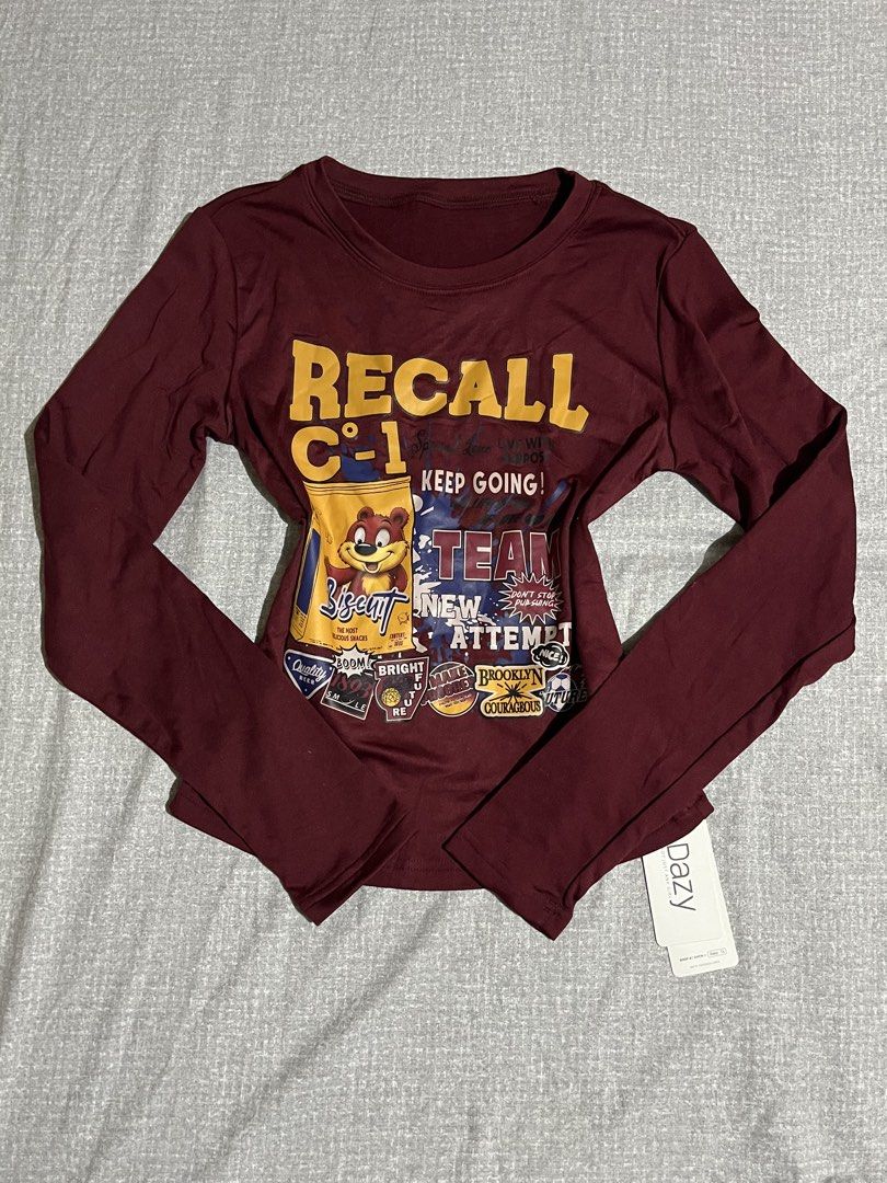 DAZY Long Sleeve Graphic Tee - Maroon (Category: Longsleeves) located in Manila. Submitted by az0r_ (Listing ID 1462502341, Image 1). Description: - Maroon long-sleeved shirt - Features 'RECALL C-1 KEEP GOING!' graphic print - Adorable cartoon bear design - Soft and comfortable fabric - Ideal for casual everyday wear - Brand new with original tag still attached - size: large.