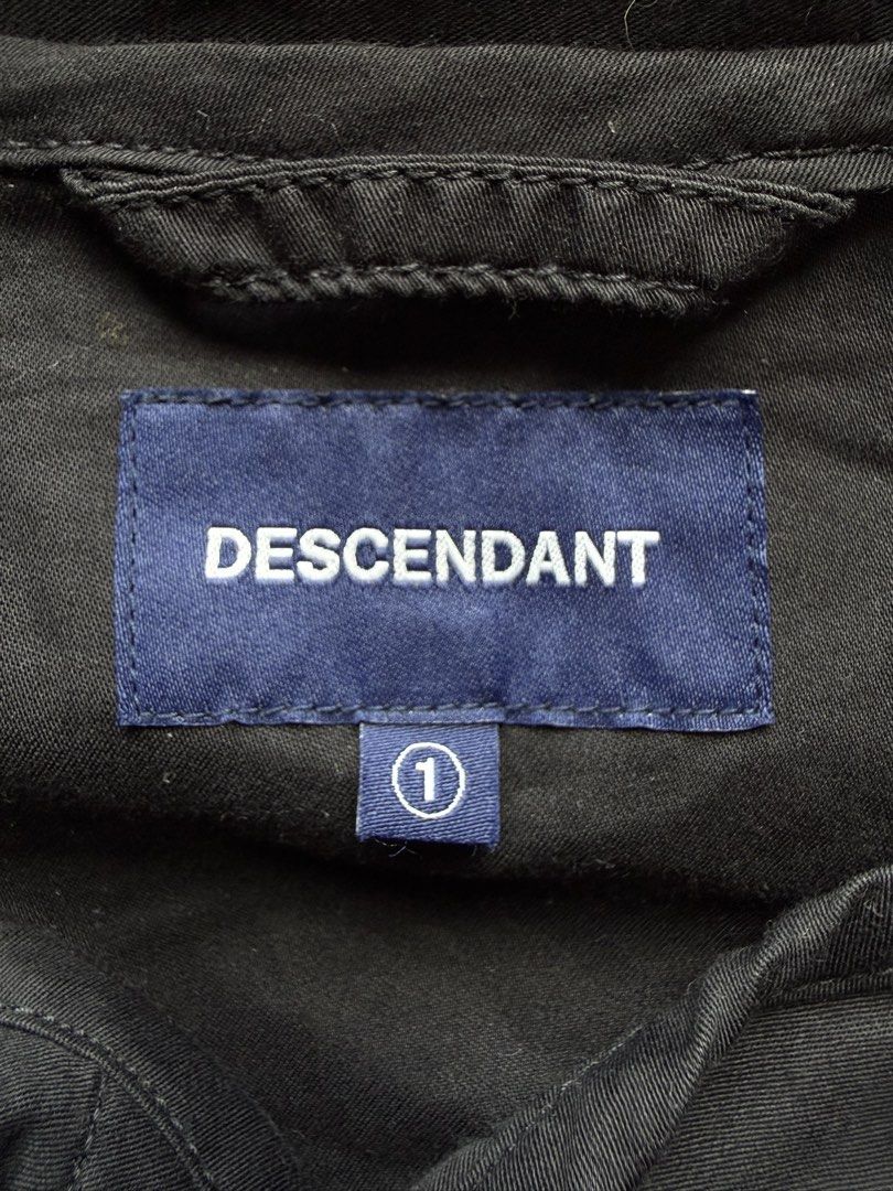 DESCENDANT Black Collarless Button-Up Shirt (Category: Tshirts & Polo Shirts ) located in Manila. Submitted by happy.we.go (Listing ID 1462536743, Image 2). Description: - DESCENDANT shirt - Collarless design - Button-up front - Chest pocket with DESCENDANT branding - Made in Japan - Tag reads: 'GIVE LIFE MEANING TOKYO JAPAN SINCE 2014' -size 1 on tag (fit to LARGE).