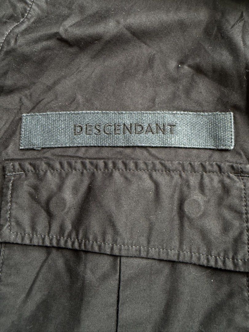 DESCENDANT Black Collarless Button-Up Shirt (Category: Tshirts & Polo Shirts ) located in Manila. Submitted by happy.we.go (Listing ID 1462536743, Image 3). Description: - DESCENDANT shirt - Collarless design - Button-up front - Chest pocket with DESCENDANT branding - Made in Japan - Tag reads: 'GIVE LIFE MEANING TOKYO JAPAN SINCE 2014' -size 1 on tag (fit to LARGE).