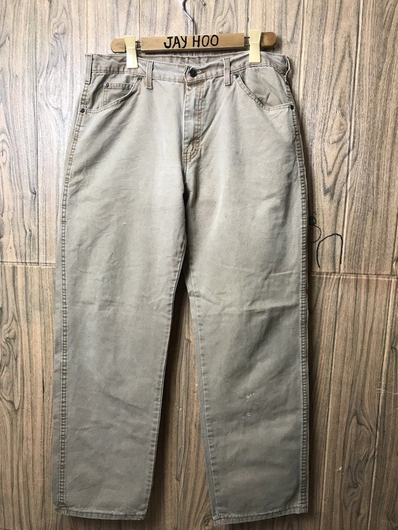 Dickies Relaxed Fit Khaki Work Pants 36x32 (Category: Jeans) located in Aloguinsan. Submitted by jayhooukay (Listing ID 1462584478, Image 2). Description: - Brand: Dickies - Color: Khaki - Size: 36x32 - Fit: Relaxed - Material: Cotton-Polyester Blend - Origin: Made in Mexico - Closure: Button Fly - Pockets: Two back pockets, one small utility pocket on right leg - Condition: Sturdy, great for work or casual wear. Minor marks on the front leg..