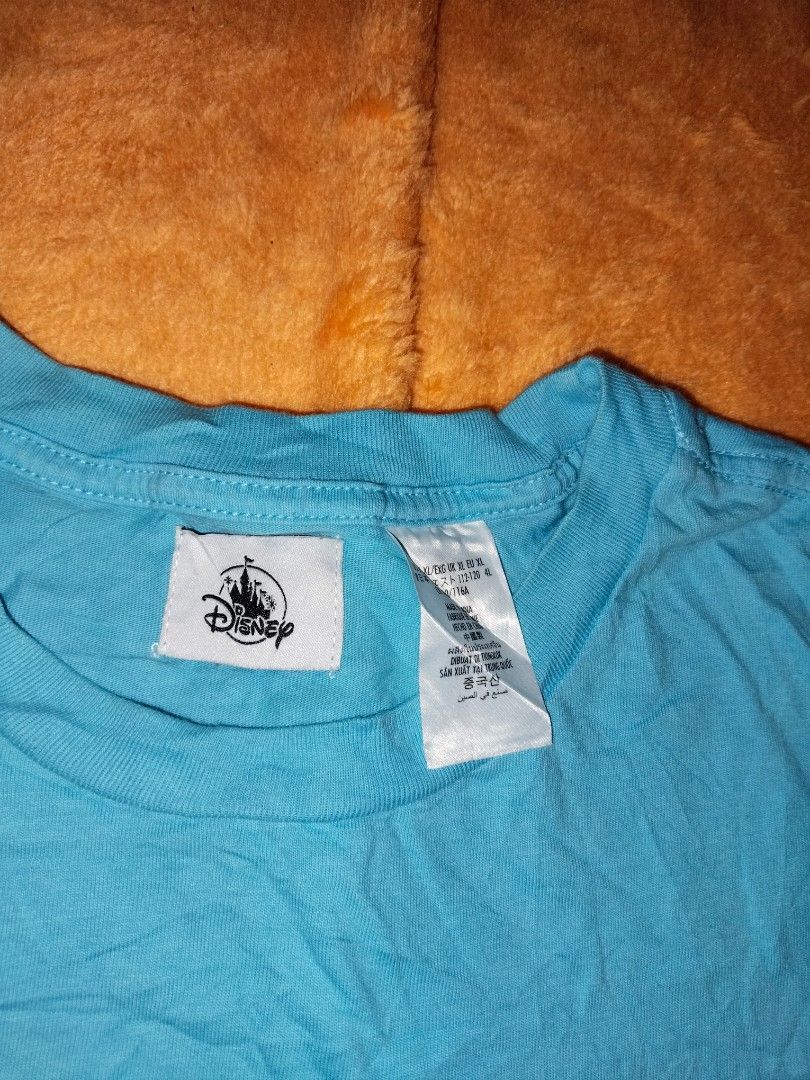 Disneyland Stitch Tee XL (Category: Tshirts & Polo Shirts ) located in Mabalacat. Submitted by al_amin_thrift (Listing ID 1462443819, Image 2). Description: Disneyland Stitch "Chill Mode" Tee — Size XL L 30 W 24 ​ - ✅ Authentic Disney Parks merchandise ​ - Super cute Stitch graphic — relaxing beach style ​ - Bright sky blue — fun & vibrant ​ - 100% soft cotton — comfortable all day ​ - Size: XL ​ - Pre‑owned: clean, no damage Genuine Disney — Sti