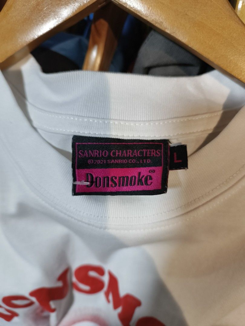 DonSmoke x Hello Kitty White T-Shirt Size L (Category: Tshirts & Polo Shirts ) located in Ipil. Submitted by khingg. (Listing ID 1462631122, Image 3). Description: - White t-shirt with exclusive DonSmoke x Kitty graphic - Features bold red text and star details on the front - Small red graphic on the back - Made from comfortable 100% cotton - Tagged as size L - Ideal for Kitty enthusiasts and streetwear lovers.