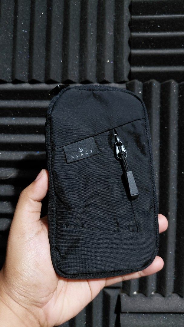 Doughnut Black Pouch (Category: Purses & Pouches) located in Pozorrubio. Submitted by aquidafinds (Listing ID 1462644700, Image 1). Description: - Brand: Doughnut - Color: Black - Main compartment with zipper - Front zippered pocket - Interior slip pocket - Light-colored interior lining - Compact size for essentials - Doughnut logo zipper pull.