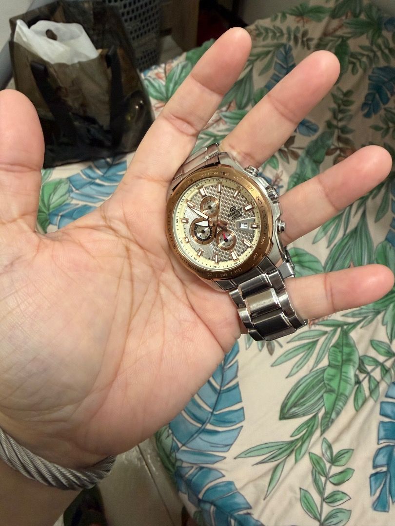 Edifice Chronograph Watch (Category: Men's Watches) located in Caloocan City. Submitted by kosmofrance (Listing ID 1462458757, Image 1). Description: - Edifice watch with chronograph function - Stainless steel band with gold accents on bezel and dial - Date display - Chronograph subdials - Fold-over clasp for secure fit - Versatile for everyday or formal wear.
