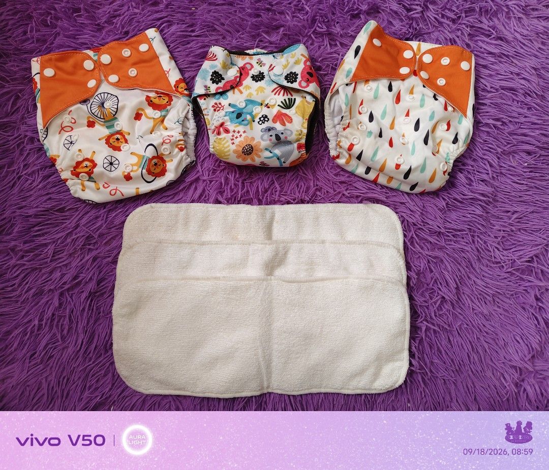 EZEFINDS 3pcs Reusable Cloth Diapers with Inserts - Cute Prints with insert (Category: Diapers & Baby Wipes) located in Cainta. Submitted by Ezefinds (Listing ID 1462446871, Image 1). Description: -2pcs Newborn to Toddler -1 pc newborn to 3mos -3pcs insert Brandnew po ito nadumihan lang sa lagayan naalis kasi sa plastic bawal sa maarte. Washable naman yung dirt niya - Set of 3 reusable cloth diapers - Features cute prints: lions & bicycles, koala