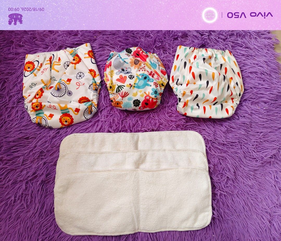 EZEFINDS 3pcs Reusable Cloth Diapers with Inserts - Cute Prints with insert (Category: Diapers & Baby Wipes) located in Cainta. Submitted by Ezefinds (Listing ID 1462446871, Image 3). Description: -2pcs Newborn to Toddler -1 pc newborn to 3mos -3pcs insert Brandnew po ito nadumihan lang sa lagayan naalis kasi sa plastic bawal sa maarte. Washable naman yung dirt niya - Set of 3 reusable cloth diapers - Features cute prints: lions & bicycles, koala