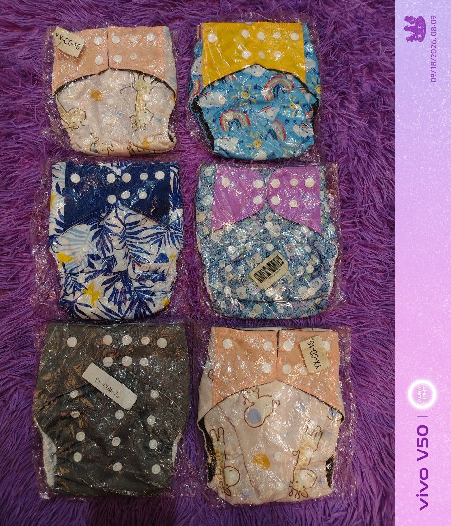 EZEFINDS Reusable Cloth Diapers with Various Cute Prints SHELL ONLY (Category: Diapers & Baby Wipes) located in Cainta. Submitted by Ezefinds (Listing ID 1462441708, Image 2). Description: - 6pcs UNUSED SHELL ONLY NO INSERT -Reusable cloth diapers - Fun patterns: giraffes, rainbows, leaves, polka dots - Individually wrapped for hygiene - Eco-conscious choice for parents - Easy to use and wash - Variety of designs available.