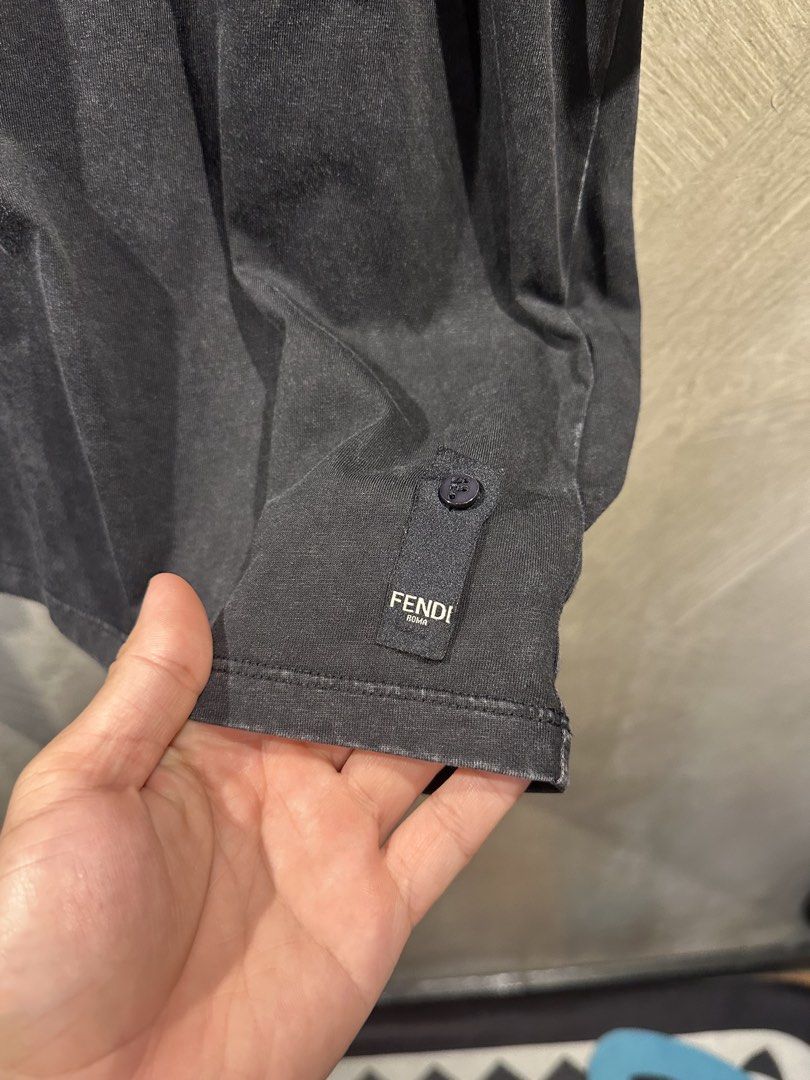 Fendi Roma T-Shirt (Category: Tshirts & Polo Shirts ) located in Manila. Submitted by gelo1999 (Listing ID 1462620004, Image 3). Description: - Authentic Fendi Roma T-shirt - Color: Charcoal grey with washed effect - Features embroidered Fendi Roma logo on chest - Small Fendi tag with button detail near hem - Made in Italy - Material: 100% Cotton - Size: M.