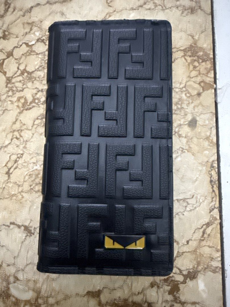 Fendi Zucca Pattern Bi-fold Wallet (Category: Wallets & Card Holders) located in Angeles City. Submitted by migs_font29 (Listing ID 1462530630, Image 1). Description: - Classic Fendi wallet with iconic Zucca pattern - Color: Black leather - Made in Italy - Interior features card slots and a note compartment - Serial number: M60326 stamped inside - Comes with a yellow Fendi card holder.