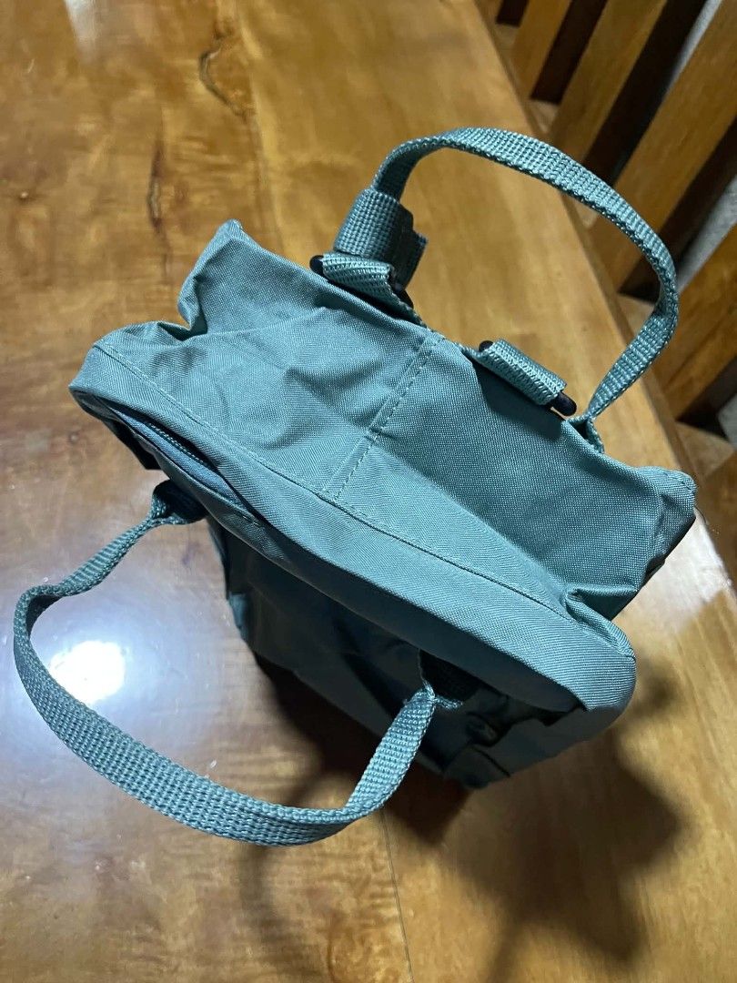 Fjallraven Kanken Mini Backpack - Green (Category: Backpacks) located in Pangantucan. Submitted by calmwhale_cb83a8 (Listing ID 1462591090, Image 2). Description: - Classic Fjallraven Kanken Mini backpack - Muted green color - Water-resistant Vinylon F fabric - Main compartment with two-way zipper - Two flat side pockets - Top handles - Adjustable shoulder straps - Ideal for everyday use or travel.