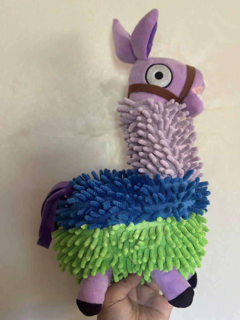 FORTNITE Marlowe The Llama Plush Toy (Category: Plushies & Soft Toys) located in Baguio. Submitted by cherylcaps95 (Listing ID 1462678178, Image 1). Description: - Adorable purple Marlowe the Llama plush toy. - Features fuzzy green, blue, and purple sections. - Comes with a cute brown bridle. - Has big, expressive eyes. - Ideal for llama collectors or as a fun decorative piece. 15” big and very stuffed. .