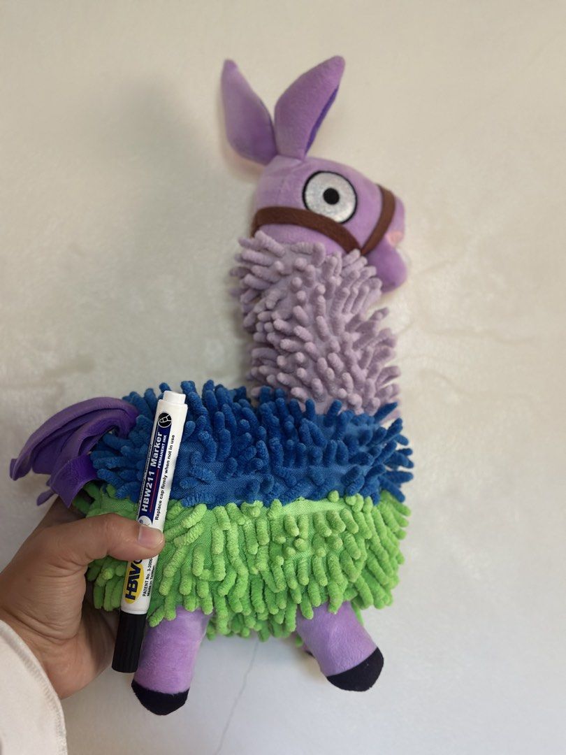FORTNITE Marlowe The Llama Plush Toy (Category: Plushies & Soft Toys) located in Baguio. Submitted by cherylcaps95 (Listing ID 1462678178, Image 2). Description: - Adorable purple Marlowe the Llama plush toy. - Features fuzzy green, blue, and purple sections. - Comes with a cute brown bridle. - Has big, expressive eyes. - Ideal for llama collectors or as a fun decorative piece. 15” big and very stuffed. .