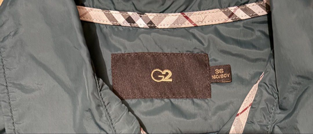 G2 Women's Green Nylon Button-Down Jacket Size 36 (Category: Coats, Jackets and Outerwear) located in Quezon City. Submitted by garagesale2026 (Listing ID 1462445093, Image 3). Description: - Used a few times - In very good condition - With detachable belt - Two front pockets; Collared neckline; Plaid pattern on inner lining - Lightweight and packable, ideal for travel or everyday wear.