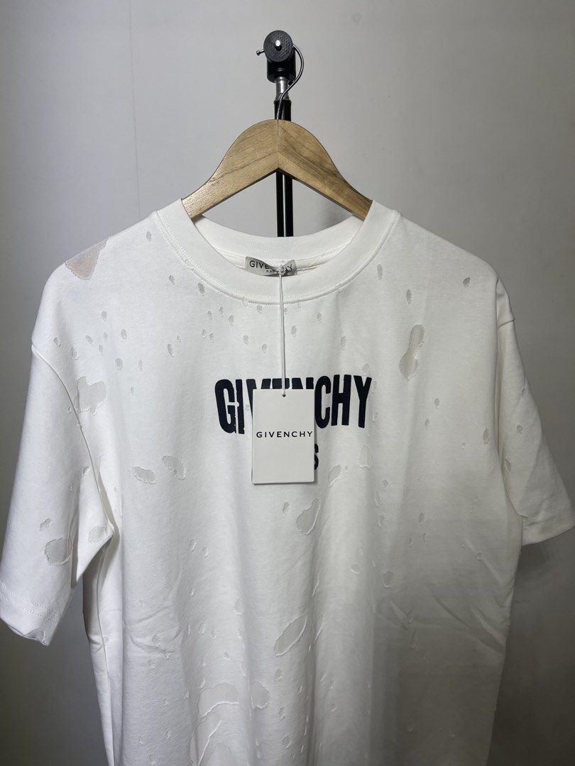 Givenchy Paris Distressed Logo T-Shirt White (Category: Tshirts & Polo Shirts ) located in Manila. Submitted by mine2ownit (Listing ID 1462652458, Image 3). Description: -m Givenchy Paris white t-shirt - Features iconic brand logo on the front - Distressed and ripped fabric for a unique, edgy look - Classic short sleeves and crew neck design - Perfect statement piece to elevate your style.