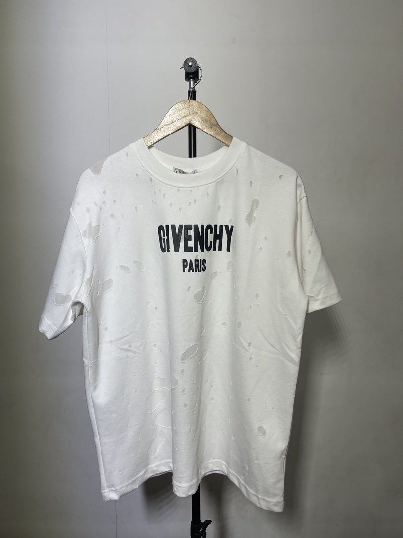 Givenchy Paris Distressed Logo T-Shirt White (Category: Tshirts & Polo Shirts ) located in Manila. Submitted by mine2ownit (Listing ID 1462652458, Image 1). Description: -m Givenchy Paris white t-shirt - Features iconic brand logo on the front - Distressed and ripped fabric for a unique, edgy look - Classic short sleeves and crew neck design - Perfect statement piece to elevate your style.