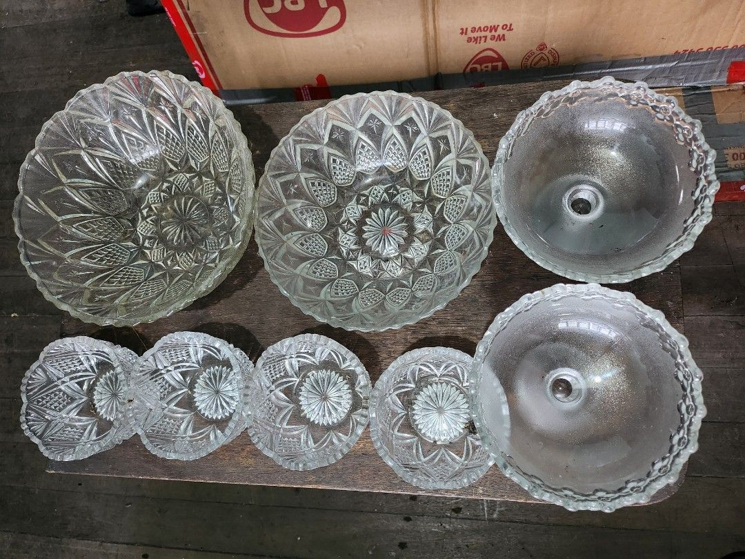 Glass Bowls and Serving Plates (Category: Dinnerware & Cutlery) located in San Juan City. Submitted by angelgrit (Listing ID 1462679280, Image 3). Description: - Set of clear glass bowls and serving plates - Features intricate, decorative patterns - Includes multiple sizes: large serving bowls, smaller individual bowls, and serving plates - Made of durable glass - Ideal for serving desserts, salads, or as decorative pieces - Adds a touch of elega