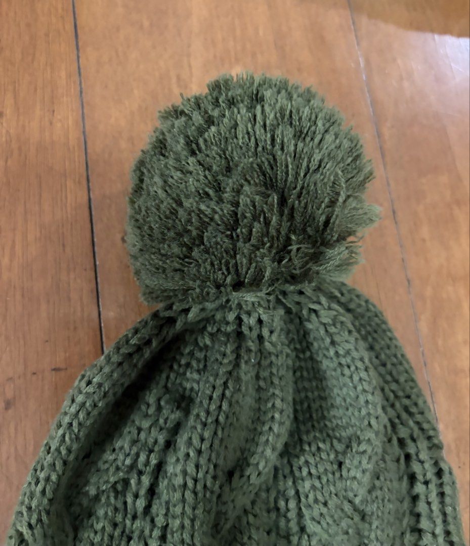 Green Cable Knit Pom Pom Beanie Hat (Category: Hats & Beanies) located in Muntinlupa City. Submitted by secondhandlove12345 (Listing ID 1462490863, Image 2). Description: - Cozy green knit beanie - Features a classic cable knit pattern - Adorned with a fluffy pom pom on top - Ribbed brim ensures a snug and comfortable fit - Ideal for keeping warm during colder weather - Simple yet stylish design For winter/autumn Negotiable Pick up by buyer .