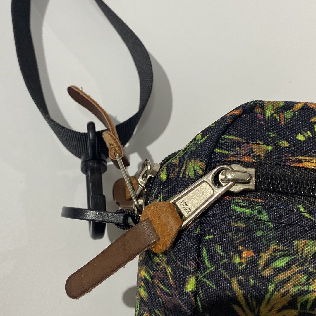 Gregory Tropical Print Crossbody Bag (Category: Cross-body Bags) located in Manila. Submitted by eddjohn (Listing ID 1462562316, Image 3). Description: - Gregory crossbody bag - Eye-catching tropical print (black base with green, yellow, orange leaves) - Two zippered compartments for secure storage - Adjustable strap for comfortable wear - Made of 100% polyester - Ideal for everyday use and travel.