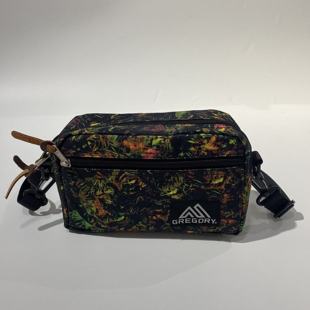 Gregory Tropical Print Crossbody Bag (Category: Cross-body Bags) located in Manila. Submitted by eddjohn (Listing ID 1462562316, Image 2). Description: - Gregory crossbody bag - Eye-catching tropical print (black base with green, yellow, orange leaves) - Two zippered compartments for secure storage - Adjustable strap for comfortable wear - Made of 100% polyester - Ideal for everyday use and travel.