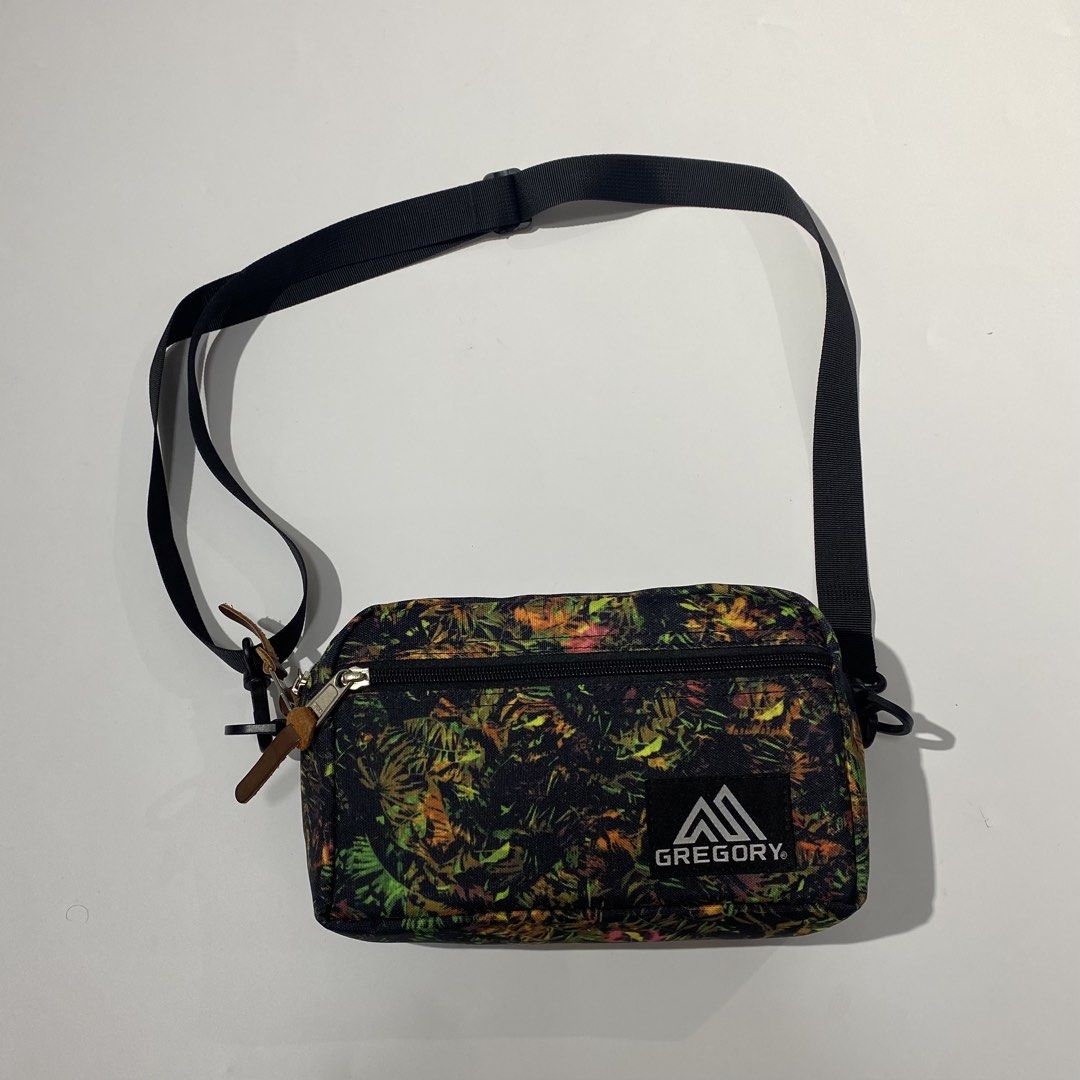 Gregory Tropical Print Crossbody Bag (Category: Cross-body Bags) located in Manila. Submitted by eddjohn (Listing ID 1462562316, Image 1). Description: - Gregory crossbody bag - Eye-catching tropical print (black base with green, yellow, orange leaves) - Two zippered compartments for secure storage - Adjustable strap for comfortable wear - Made of 100% polyester - Ideal for everyday use and travel.