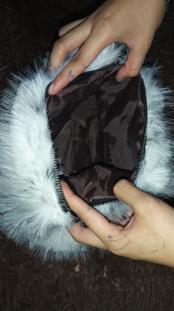 Grey Faux Fur Bag with Chain Strap (Category: Shoulder Bags) located in Lapu Lapu. Submitted by messdup (Listing ID 1462511754, Image 2). Description: - Adorable grey and white faux fur bag - Versatile strap options: silver chain and black faux leather - Secure zipper closure - Lined with dark brown fabric - Ideal for evening events or a fun fashion statement.