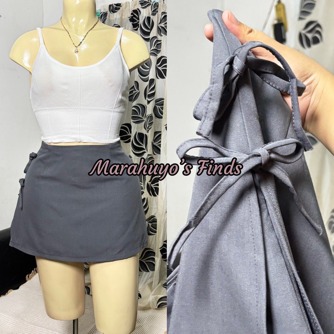 Grey Mini Skirt with Inner Short Size M (Category: Skirts) located in Mabalacat. Submitted by marahuyos.finds (Listing ID 1462453840, Image 2). Description: - Grey mini skirt - Built-in inner shorts - Size: Medium - Waist fit: 28-29 inches - Length: 12 inches - Cute tie details on the sides - Ideal for casual wear.