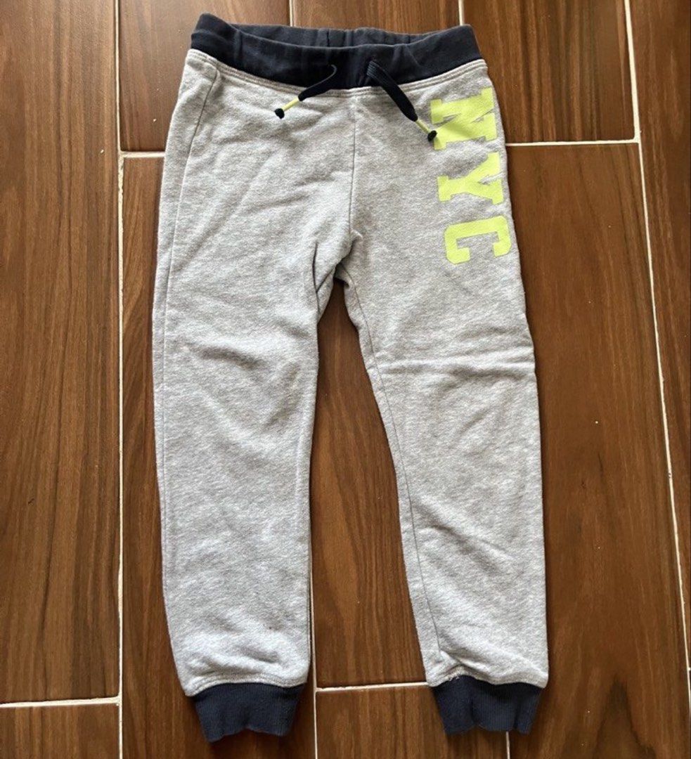 Grey NYC Joggers with Drawstring Waist (Category: Other Bottoms) located in Las Pinas. Submitted by chelcie.sindhy (Listing ID 1462459472, Image 1). Description: - Grey joggers - Dark waistband and cuffs - Bright yellow 'NYC' graphic on right leg - Drawstring for adjustable fit - Comfortable and casual - Great for everyday wear.