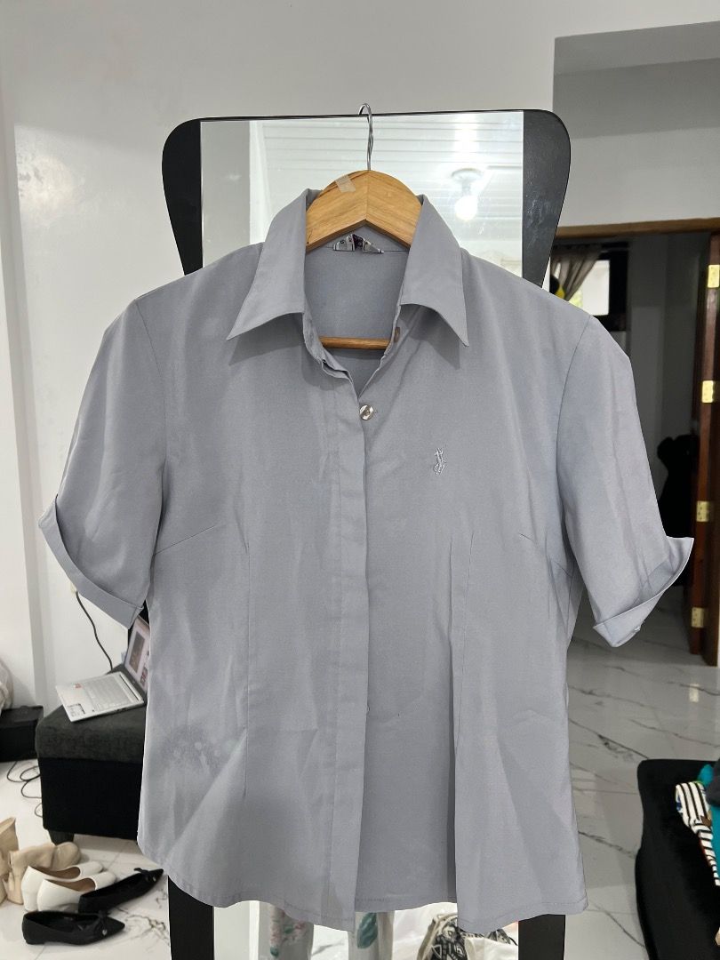 Grey Short Sleeve Button Up Shirt with Logo (Category: Tshirts & Polo Shirts ) located in Baguio. Submitted by pureearth.5f1c08 (Listing ID 1462544805, Image 1). Description: - Grey short sleeve button up shirt - Small embroidered logo on chest - Classic collar - Cuffed sleeves - Versatile for casual or work attire.