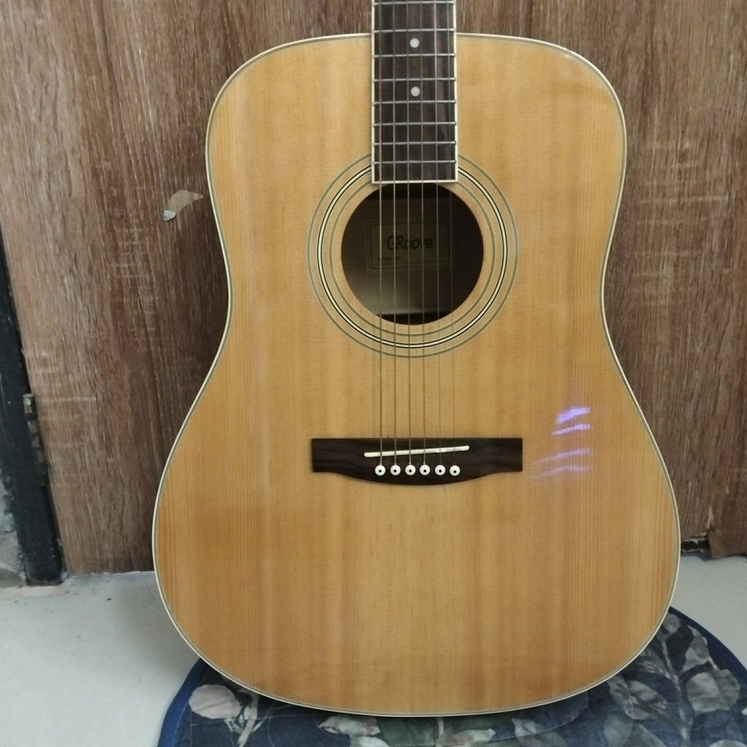 Groove Acoustic Guitar (Category: Musical Instruments) located in San Fernando. Submitted by shanesofi (Listing ID 1462462282, Image 1). Description: - Groove acoustic guitar - Natural wood finish on body and neck - Darker wood accent on the back - Six tuning pegs on the headstock - Ideal for beginners or casual players - Ready for its new owner.