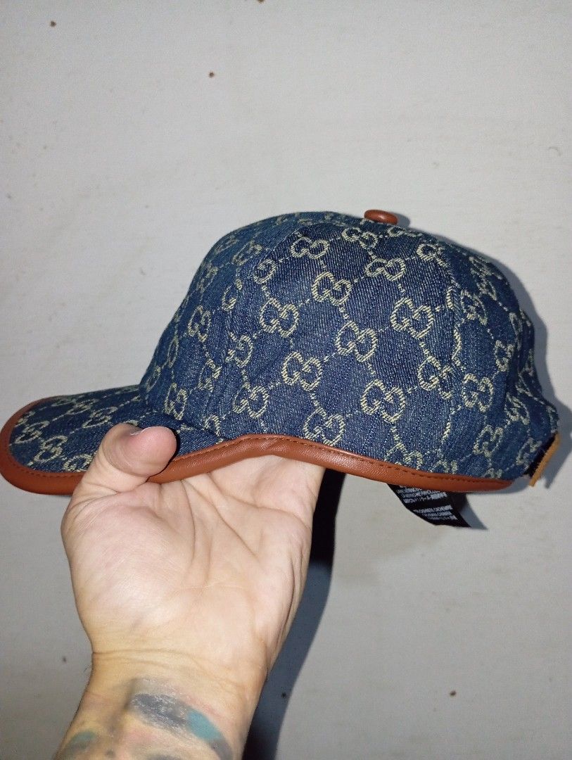 Gucci Denim GG Monogram Cap (Category: Caps & Hats) located in Manila. Submitted by brugodoy (Listing ID 1462516683, Image 3). Description: - Iconic Gucci GG monogram denim cap - Features stylish brown leather trim - Adjustable strap for a comfortable fit - Perfect for casual, everyday wear - Shows some signs of use, but remains in good overall condition.