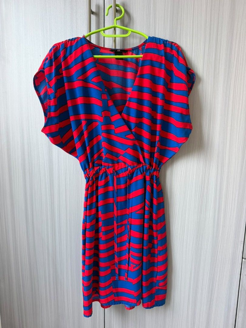 H&M Red Blue Striped Wrap Dress (Category: Dresses) located in Consolacion. Submitted by i.am.xs.or.s (Listing ID 1462536196, Image 3). Description: - Cute H&M wrap dress - Red and blue wavy stripe pattern - Elasticated waist with drawstring - Short, fluttery sleeves - Ideal for casual outings or beach days - Easy to wear and style.