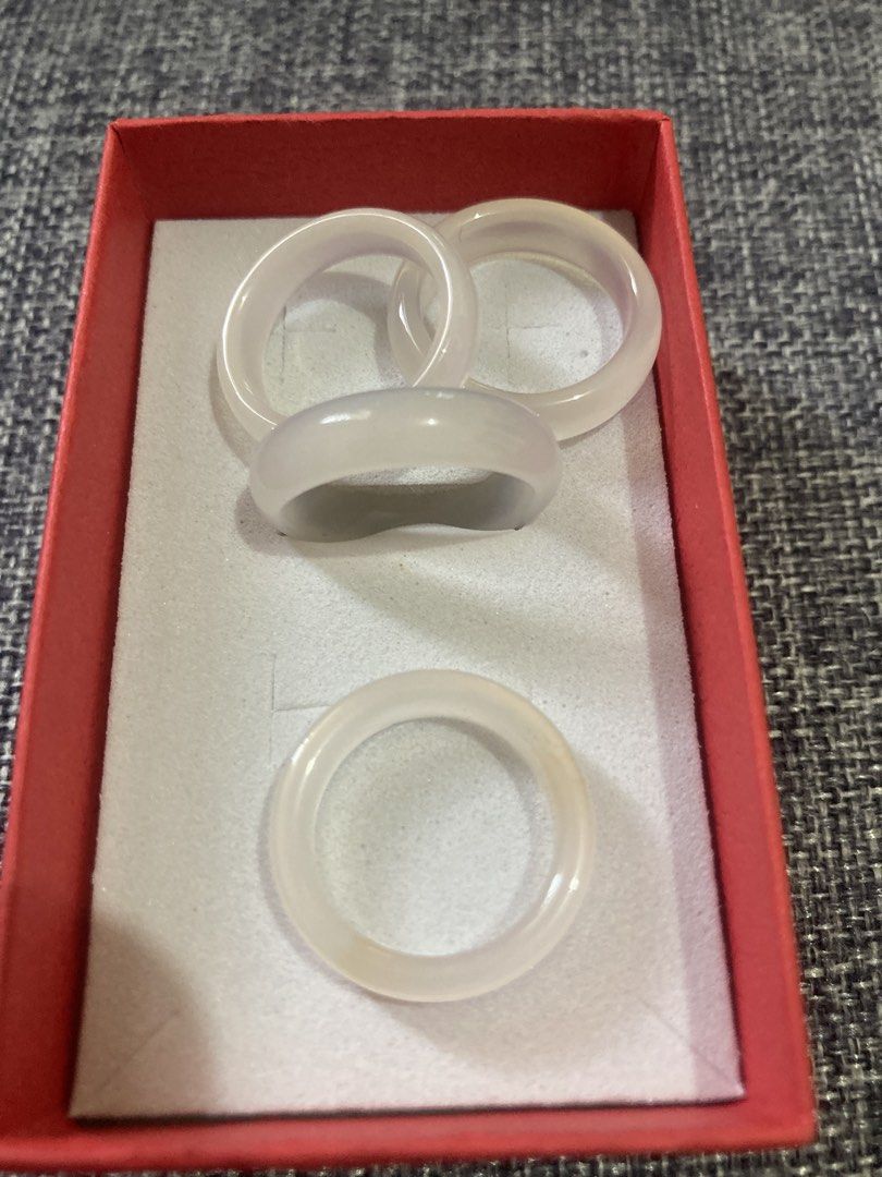 Jade and Agate Rings Set (Category: Rings) located in Valenzuela. Submitted by theaveqc04360 (Listing ID 1462605805, Image 2). Description: - Bangle band rings: 2 light green jade, 1 translucent grey agate and white jade - Also includes a set of darker rings, possibly obsidian. - Some rings come with their original certification cards. - Selling per piece.