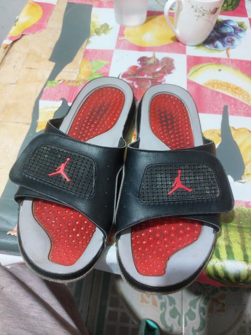 Jordan Flight Slides Black Red (Category: Slippers & Slides) located in Manila. Submitted by mightyturtle_e6e74b (Listing ID 1462491430, Image 1). Description: - Black Jordan slides with red accents - Features the iconic Jumpman logo and 'Flight' text - Grippy sole pattern for good traction - Perfect for casual wear or post-sports relaxation - Shows some signs of wear on straps and soles (please check photos for details).