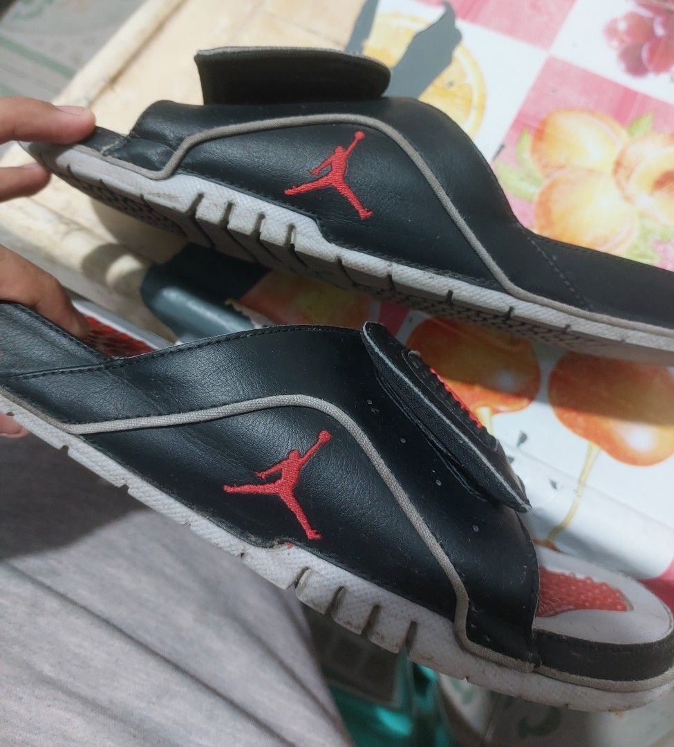 Jordan Flight Slides Black Red (Category: Slippers & Slides) located in Manila. Submitted by mightyturtle_e6e74b (Listing ID 1462491430, Image 3). Description: - Black Jordan slides with red accents - Features the iconic Jumpman logo and 'Flight' text - Grippy sole pattern for good traction - Perfect for casual wear or post-sports relaxation - Shows some signs of wear on straps and soles (please check photos for details).